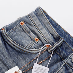 Purple‑Brand Light Blue Multi‑Patch Repair Distressed Straight Leg Jeans